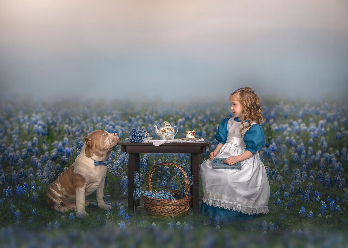 Young girl and dog having a whimsical tea party in a field of blue flowers, capturing the magical bond between children and animals