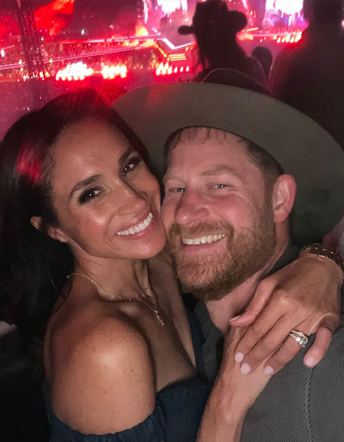 Meghan Markle and Prince Harry smiling and hugging at an event, sharing a moment related to Mother&rsquo;s Day snap of Lilibet and Archie.