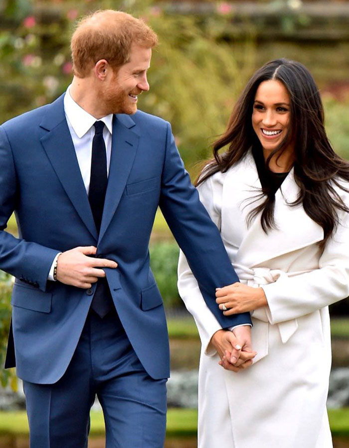 Prince Harry and Meghan Markle smiling and holding hands outdoors, highlighting Meghan Markle's Montecito neighbor claims.