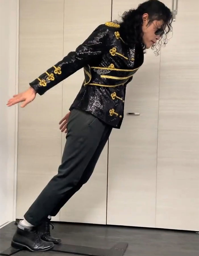 Person dressed as Michael Jackson performing the iconic lean pose, sparking new doubts about the move years after his passing.