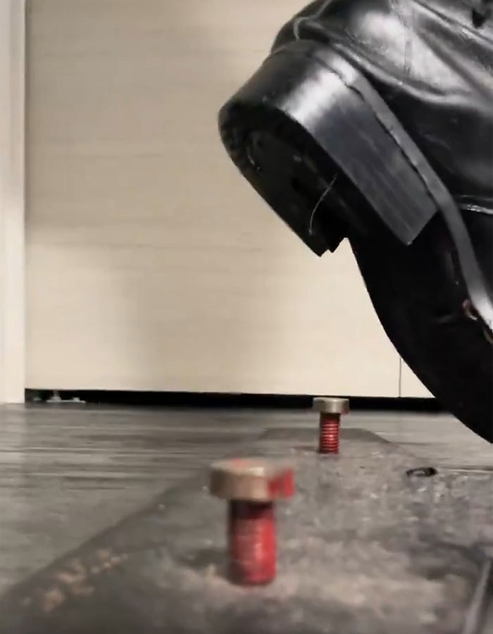 Close-up of black leather shoe and bolts highlighting Michael Jackson's iconic lean and related doubts years after his passing.