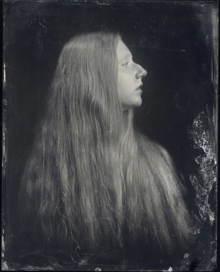 Black and white vintage portrait of a young woman with long hair in a single frame, 2025 One Shot Photo Contest winner.