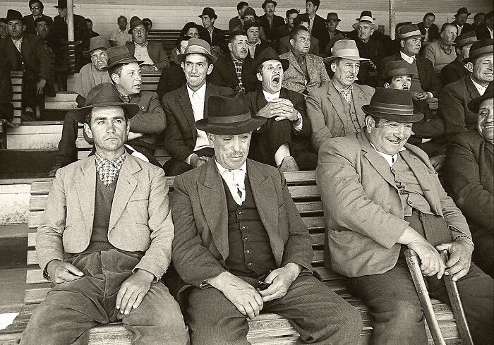 Black and white vintage photo capturing a diverse group of men in hats and suits, showcasing the power of a single frame.
