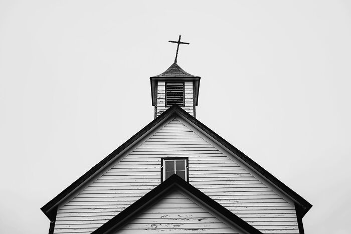 Black and white photo of a church steeple with cross, showcasing the power of a single frame in the 2025 photo contest.