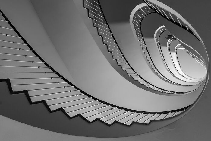Spiral staircase in black and white showcasing the power of a single frame from the 2025 one shot photo contest winners.