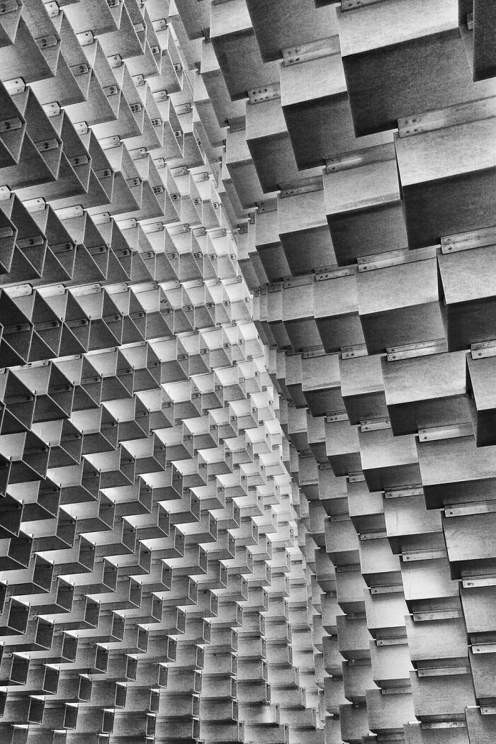 Abstract geometric pattern formed by repetitive rectangular shapes in black and white, showcasing power of a single frame photo.