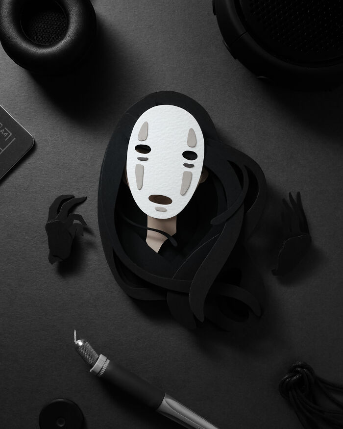 Intricate paper art featuring a black and white character with layered details, showcasing incredible paper art craftsmanship.