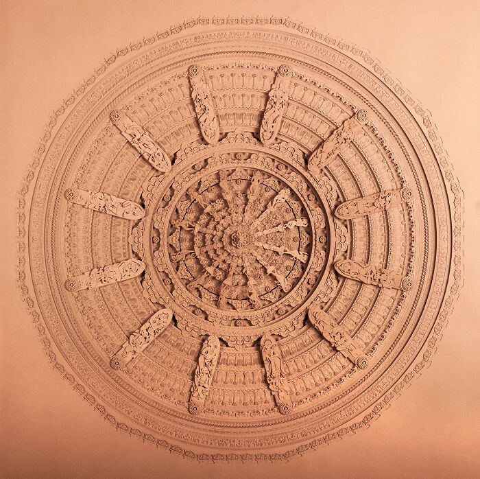 Intricate paper art sculpture featuring detailed circular patterns and carvings showcasing incredible craftsmanship.