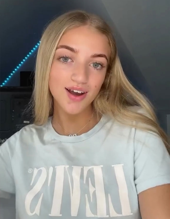 Princess Andre wearing a light Levi's shirt, responding to online trolls after buying a $13,000 car in a casual indoor setting.