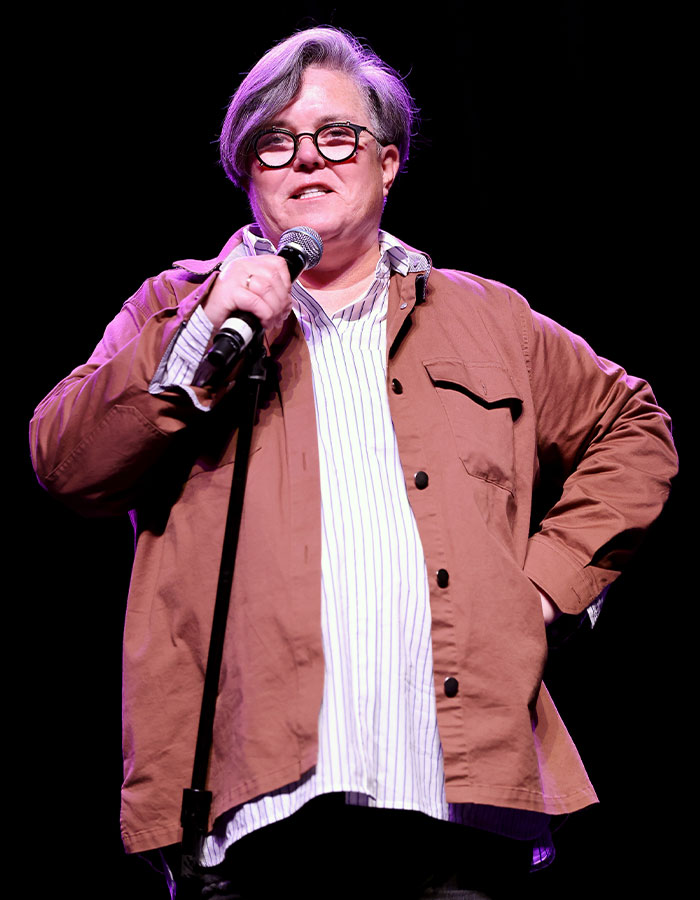 Rosie O&rsquo;Donnell speaking on stage, wearing glasses and a brown jacket, showcasing dramatic Mounjaro weight loss transformation.