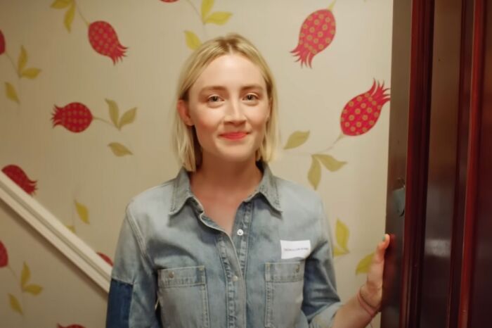 Young actress in a denim shirt smiling at the camera, featured in Hollywood fans guessing actor movie lists.
