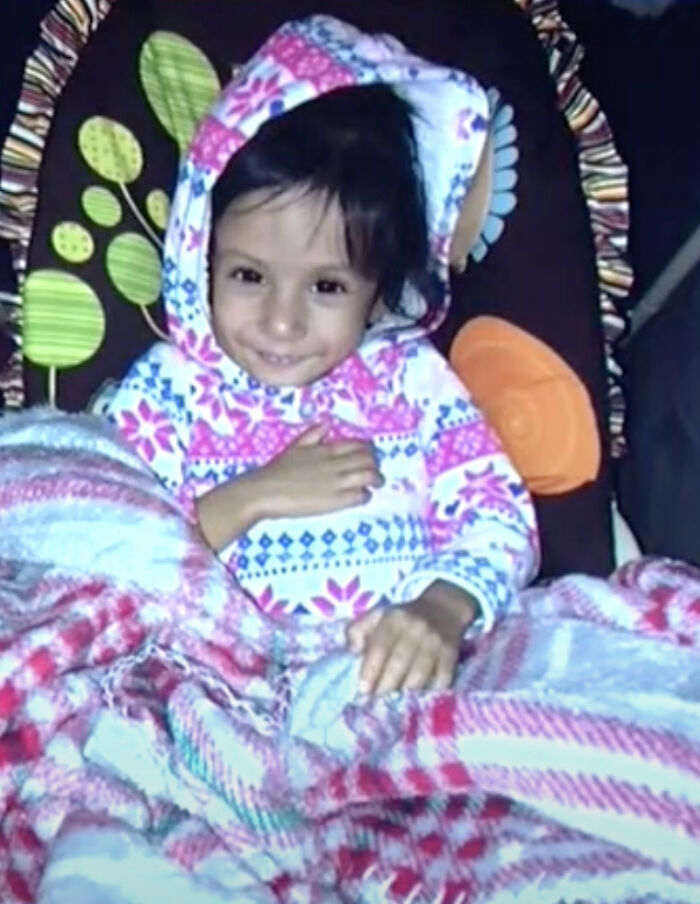 7-year-old girl found in a closet wrapped in blankets, smiling and wearing a colorful floral hoodie 7-year-old girl found in a closet wrapped in blankets, smiling and wearing a colorful floral hoodie