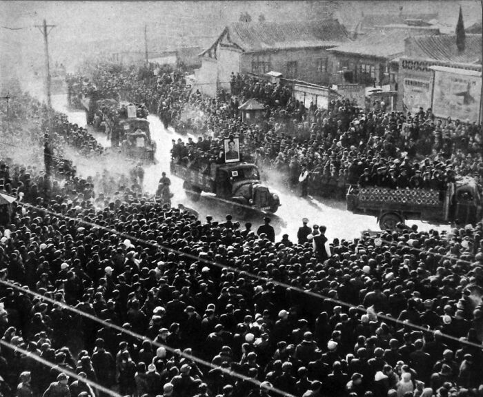 Large crowd gathers along street during a historic event symbolizing one of the biggest mistakes that changed history.