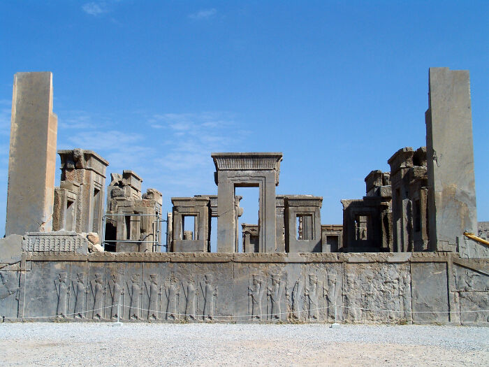 Ancient stone ruins with detailed carvings under a clear blue sky, showcasing hidden UNESCO gems and historic sites.