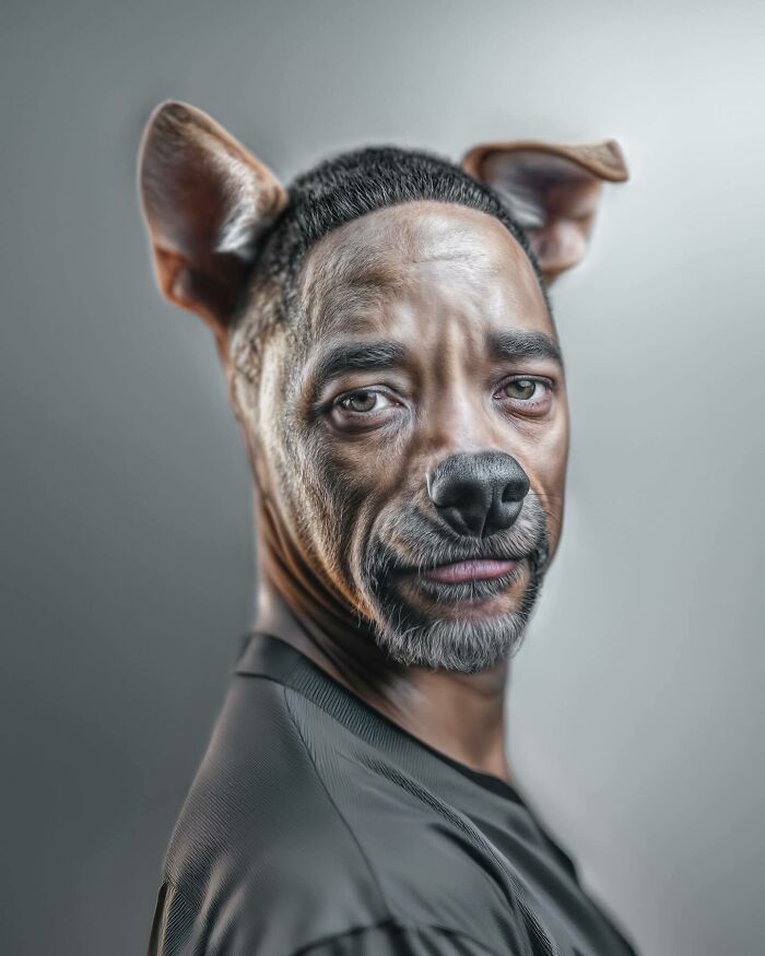 Man with blended human and dog features posing against a neutral background showcasing animal and human identity fusion.