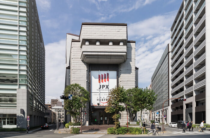 JPX Tokyo Stock Exchange building in cityscape, symbolizing biggest mistakes that changed the course of history.