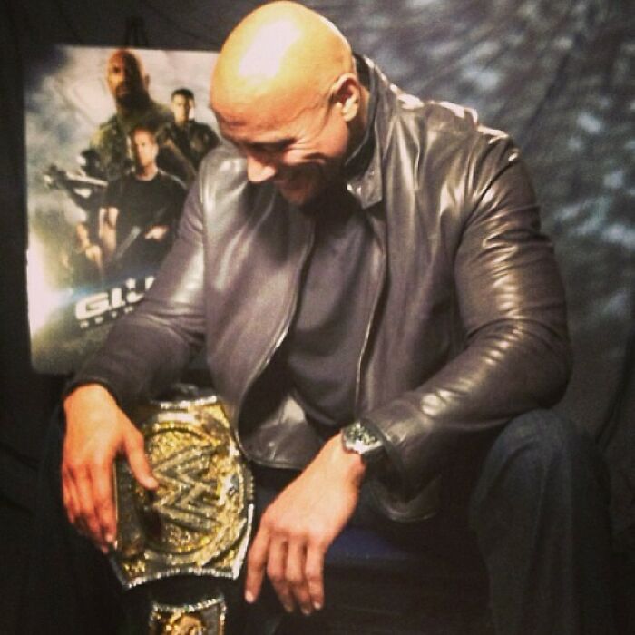 Celebrity wearing a leather jacket sitting with a championship belt, a classic Instagram post from way back in the day.