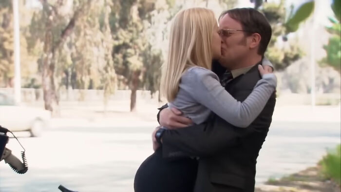 Actors sharing an intense on-screen kiss during filming, showcasing behind-the-scenes moments from movies and TV.