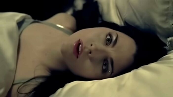 Woman lying on bed looking surprised and thoughtful, reflecting the theme of fascinating today I learned facts.