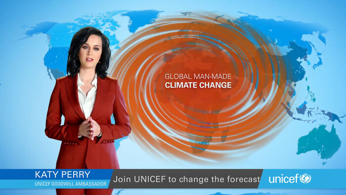 Katy Perry in a red suit presenting a UNICEF climate change campaign with a world map and swirling orange patterns.