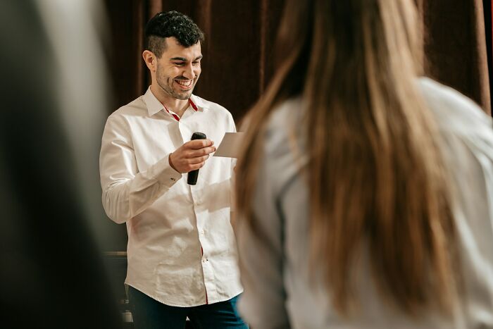 Man in white shirt sharing industry secrets during a presentation, revealing what they're really like behind closed doors.
