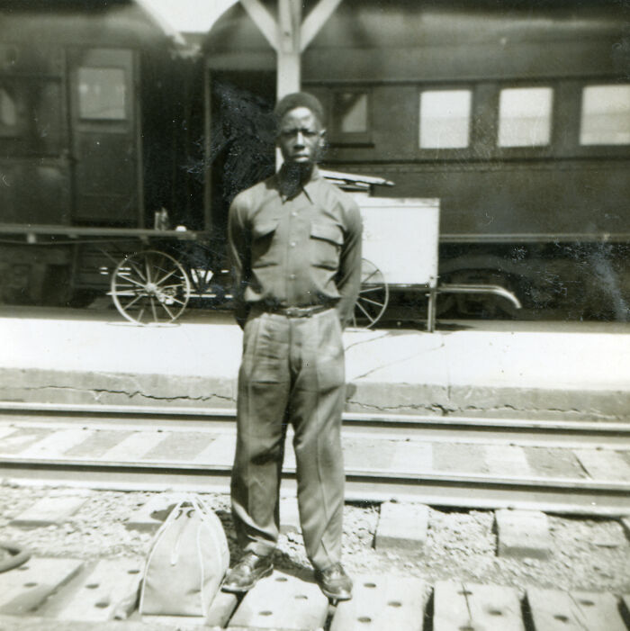 Black and white photo of a man standing by train tracks, illustrating unusual and tragic things that actually happened.