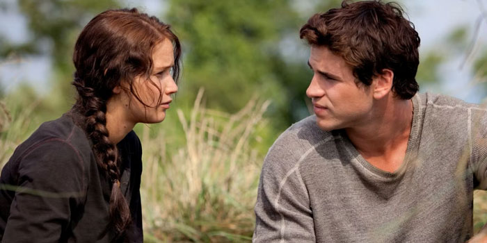 Two young celebrities in an outdoor setting, engaging in a serious conversation about hygiene habits.