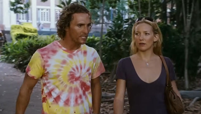 Two celebrities walking outdoors having a conversation, highlighting hygiene habits and brushing concerns.