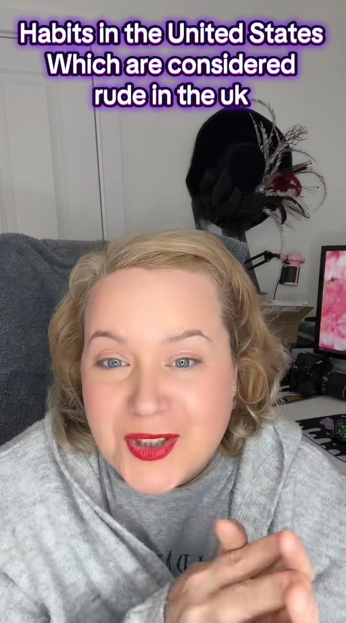 American woman in UK discusses how her usual US habits are considered rude by the British in a casual indoor setting.