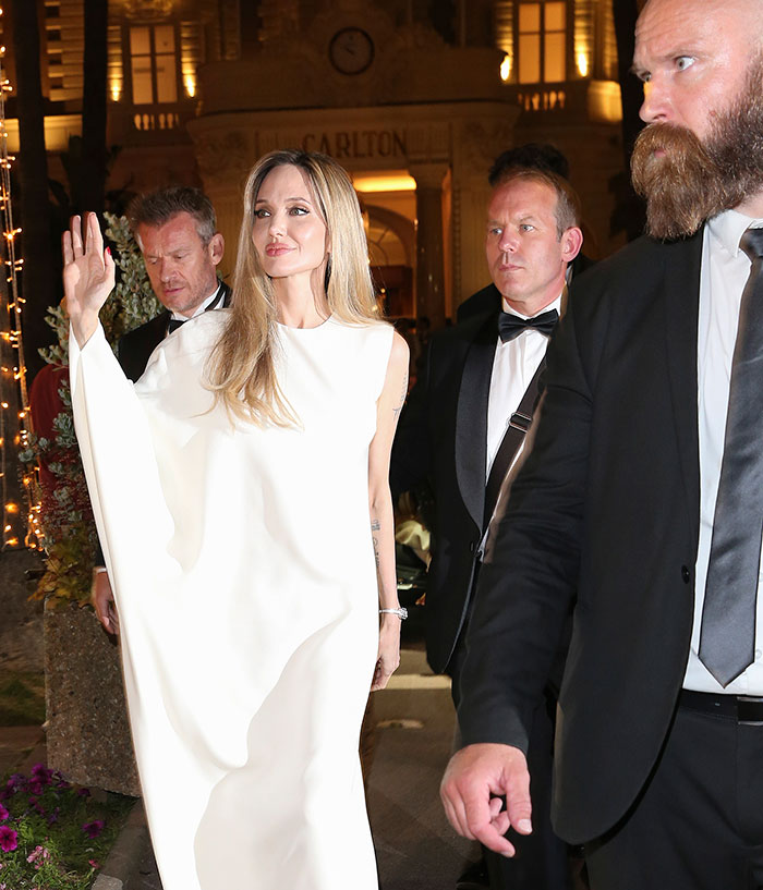 Angelina Jolie walking with bodyguard and security, sparking concerns after uncomfortable moments caught on camera.