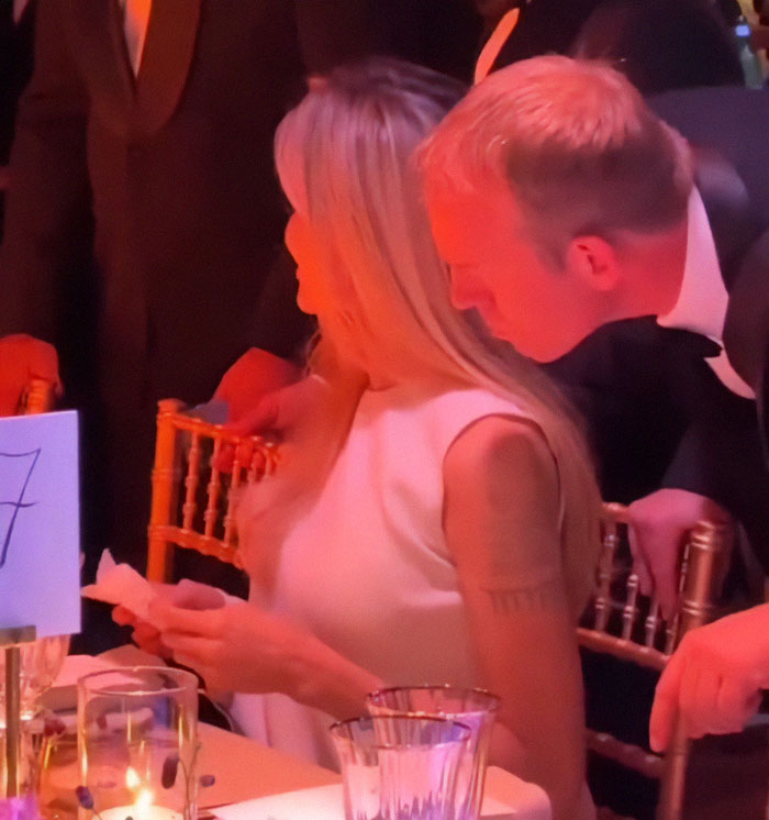 Angelina Jolie in an uncomfortable moment with bodyguard at a formal event, highlighting rising concerns.