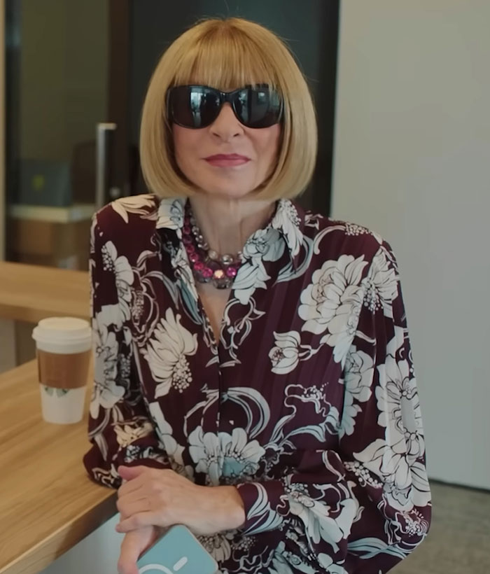 Woman with blonde bob haircut and sunglasses wearing floral blouse, symbolizing Anna Wintour amid Met Gala 2025 feud news.
