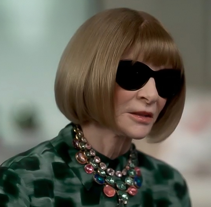Anna Wintour wearing dark sunglasses and a colorful necklace, sparking Met Gala dress stain gossip. Anna Wintour wearing dark sunglasses and a colorful necklace, sparking Met Gala dress stain gossip.