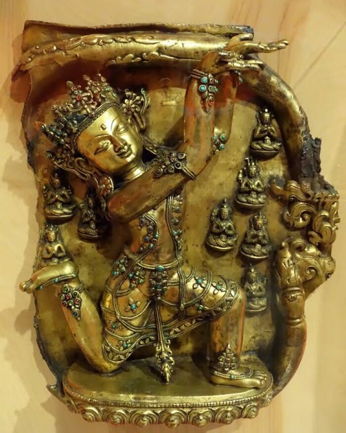 Bronze archeological art sculpture of a dancing deity adorned with turquoise and coral stones.