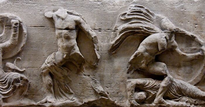 Ancient archeology and art carved in stone depicting human figures in dynamic poses on a historic archeological wonder.