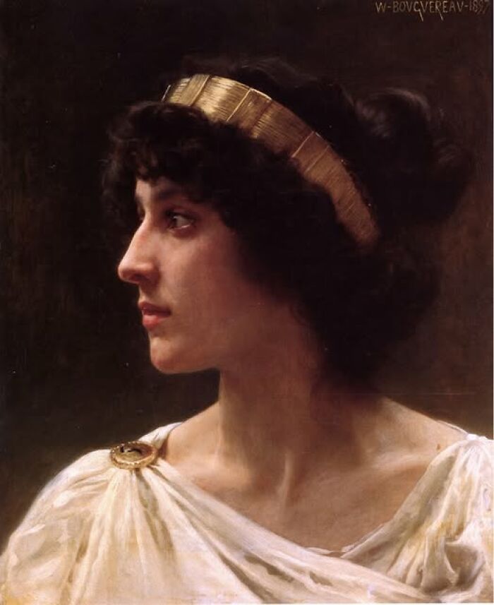Portrait of a woman wearing a gold headband and ancient-style white clothing, representing archeology and art themes.