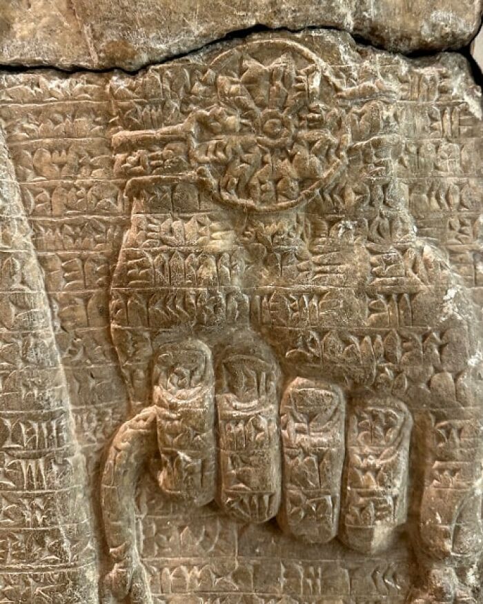 Ancient stone carving with intricate archeological symbols and figures showcasing archeology and art on a weathered surface.