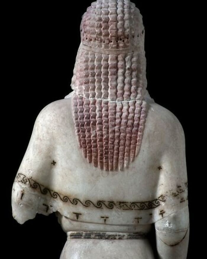 Ancient marble statue with detailed hair and patterns, showcasing archeology and art in historic archeological wonders.