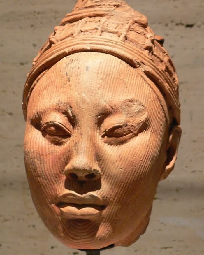 Terracotta bust of an ancient figure with detailed facial features showcasing archeology and art craftsmanship.