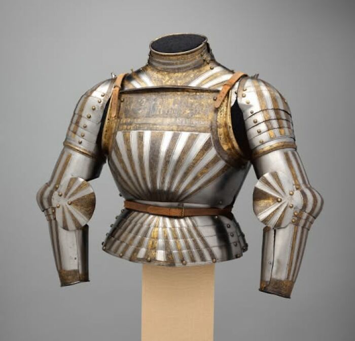 Armored breastplate and arm guards from an ancient suit of armor, an archeological wonder showcasing art and craftsmanship.