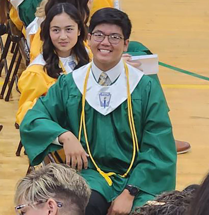 High school valedictorian in green graduation gown at ceremony triggers punishment must fit the crime debate.