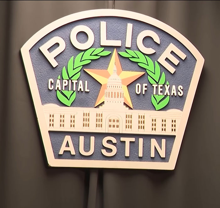 Austin Police Department badge displayed against a black background relating to mom who locked 7YO starving child case.