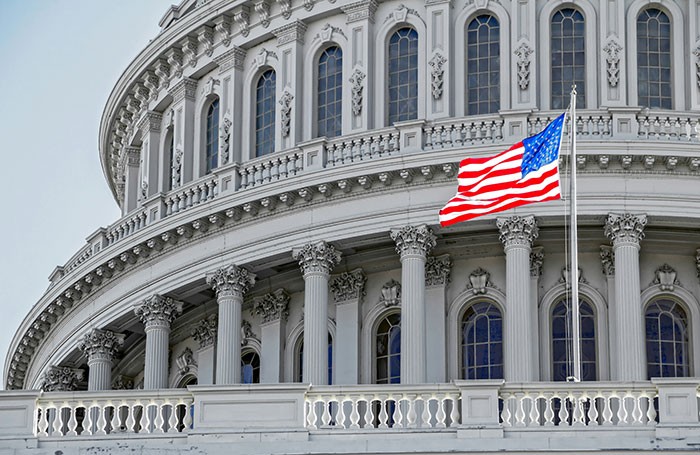 Close-up of the U.S. Capitol building with an American flag, symbolizing moments where massive awkward truths were ignored.