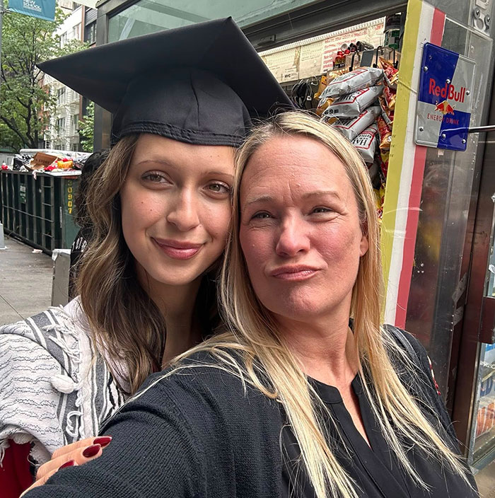 Two women smiling for a selfie outside, with one wearing a graduation cap, relating to Hadid secret sister news. Two women smiling for a selfie outside, with one wearing a graduation cap, relating to Hadid secret sister news.
