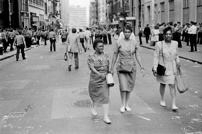 Three women walking confidently on a city street, capturing the essence of humanity in an IPA 2024 Best Of Show image.