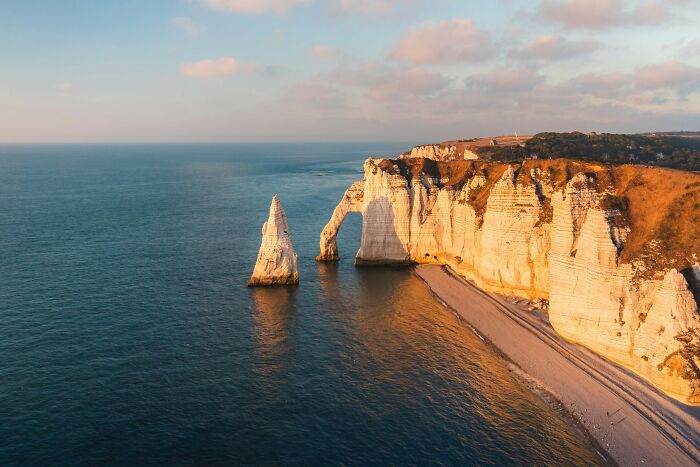 Rock formations along the coast at sunset showcasing natural wonders that prove the world is still full of magic.