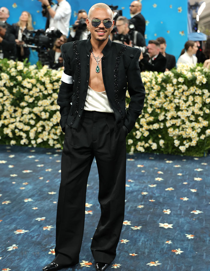 Man wearing black embellished jacket with white top and black trousers at a Met Gala event, showcasing fashion fails style.