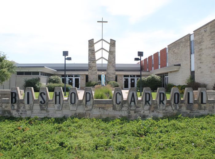 Bishop Carroll High School building with sign and cross, related to HS valedictorian stripped of title controversy.