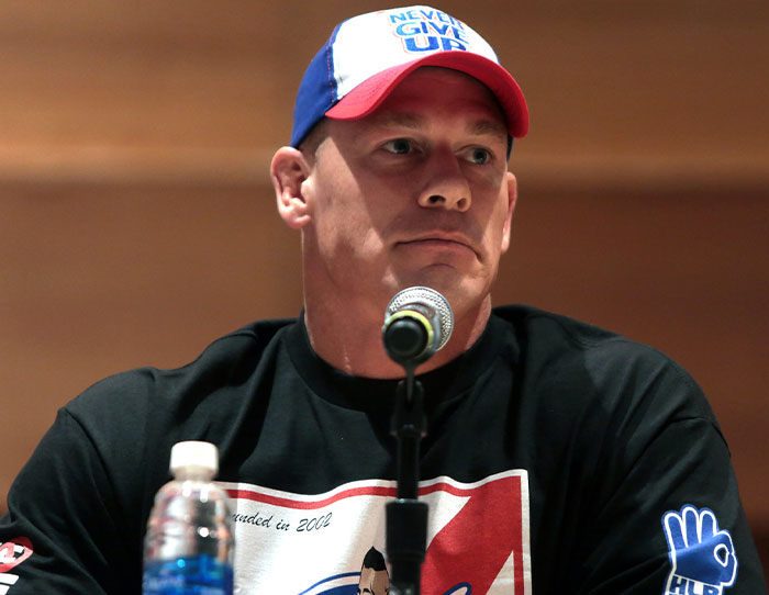 Man wearing a cap speaking into a microphone, representing stories of the strangest ways people crossed paths with celebs.