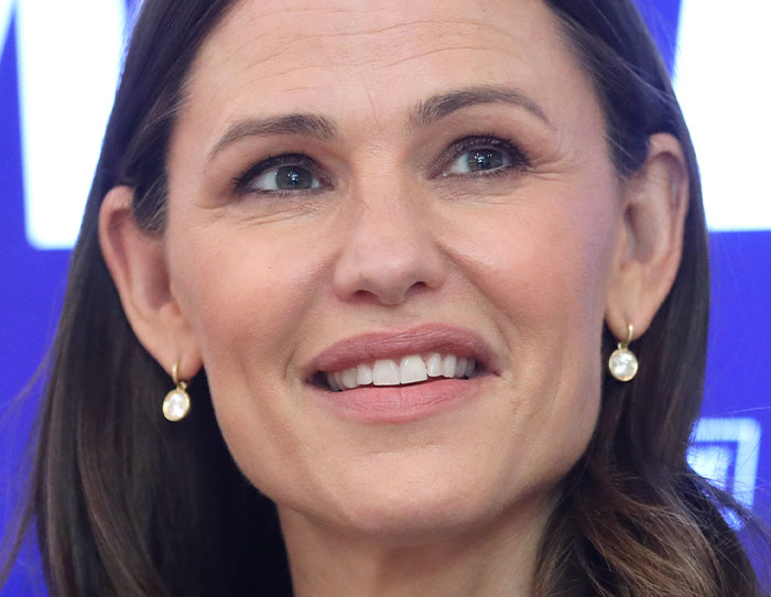 Close-up of a woman smiling at a public event, illustrating the theme of crossing paths with celebs.